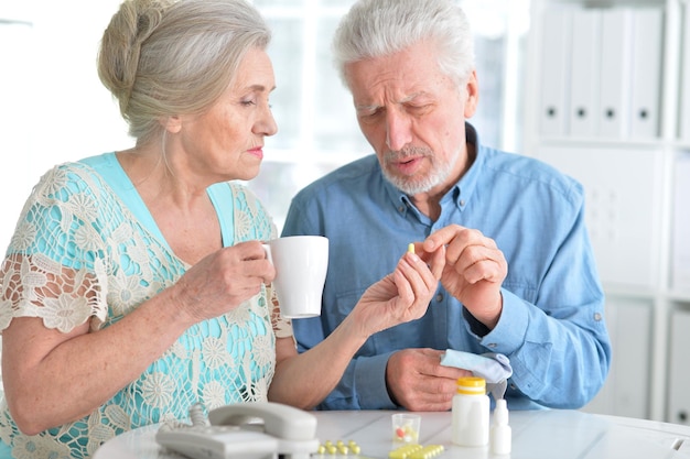 Portrait of an elderly couple with pills