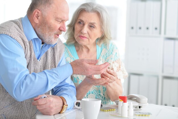 Portrait of an elderly couple with pills