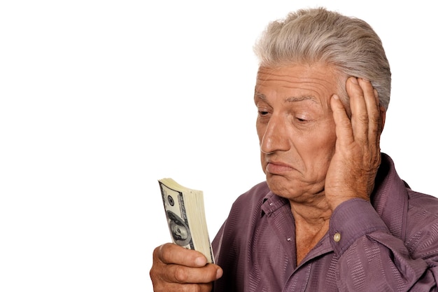 Portrait of elderly man holding dollars on white background