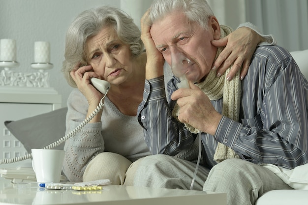 Portrait of elderly man with flu inhalation