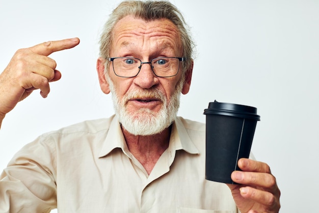 Portrait elderly man with a gray beard in a shirt and glasses isolated background