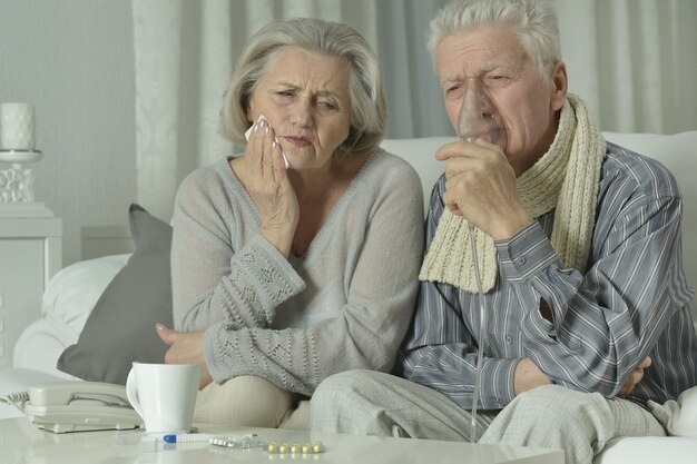 Portrait of elderly man and woman with flu