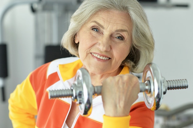 Portrait of elderly woman exercising in gym