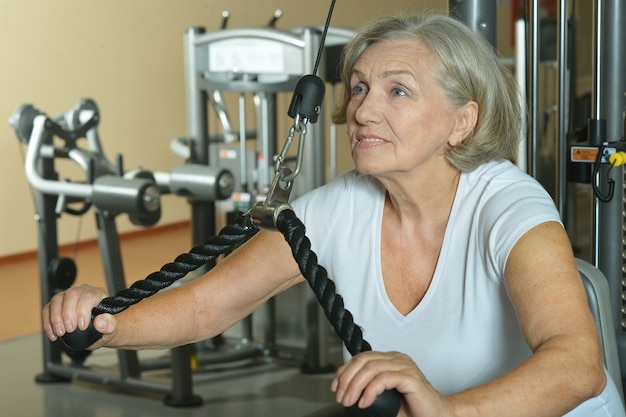 Portrait of elderly woman exercising in gym