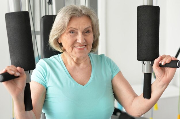 Portrait of elderly woman exercising in gym