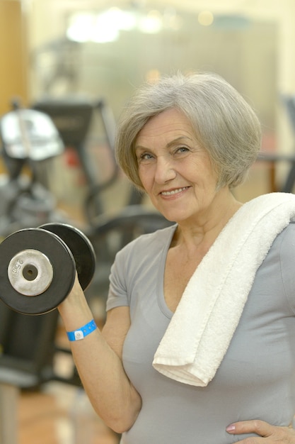 Portrait of elderly woman exercising in gym