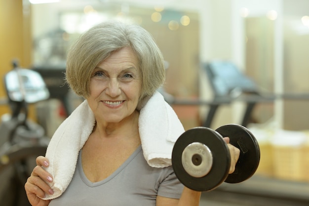 Portrait of elderly woman exercising in gym