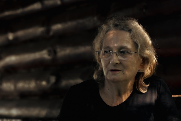 Portrait of elderly woman in glasses closeup on natural background Profile of man with sunset sunlight on his face