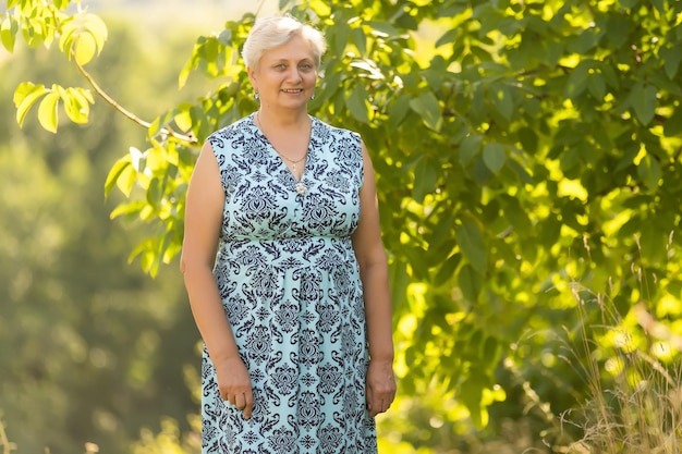 Portrait of the elderly woman. A photo on outdoors