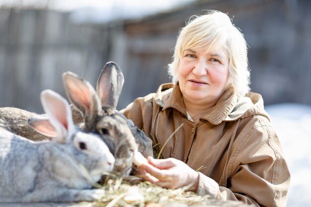 Portrait of an elderly woman with a pet rabbit