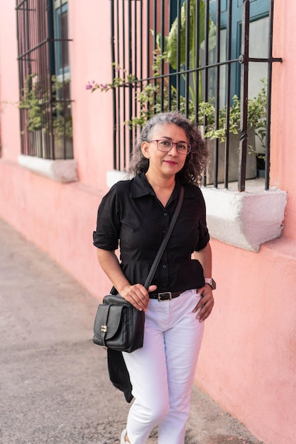 Portrait of an elegant Latina woman outdoors looking at the camera