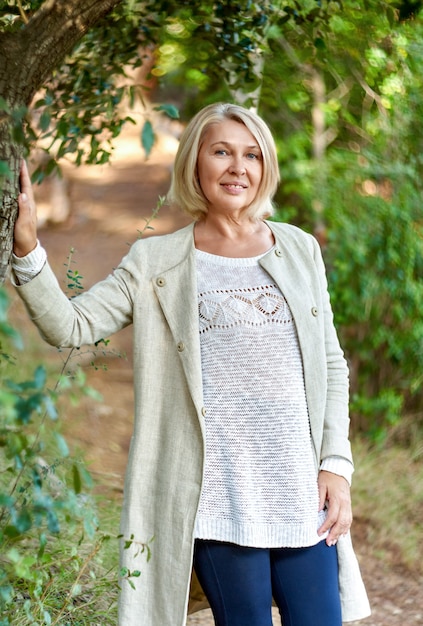 Portrait of elegant mature woman in the forest