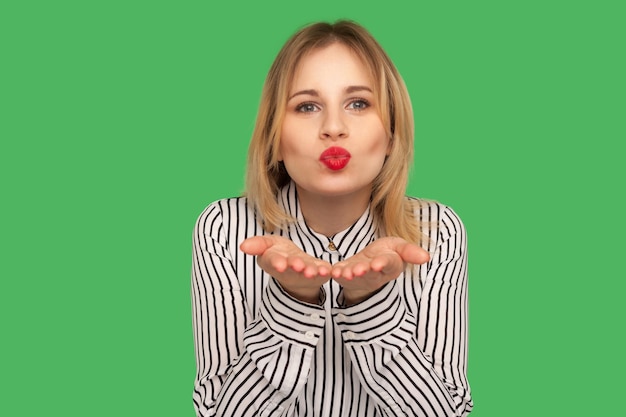 Portrait of emotional blonde woman on green background