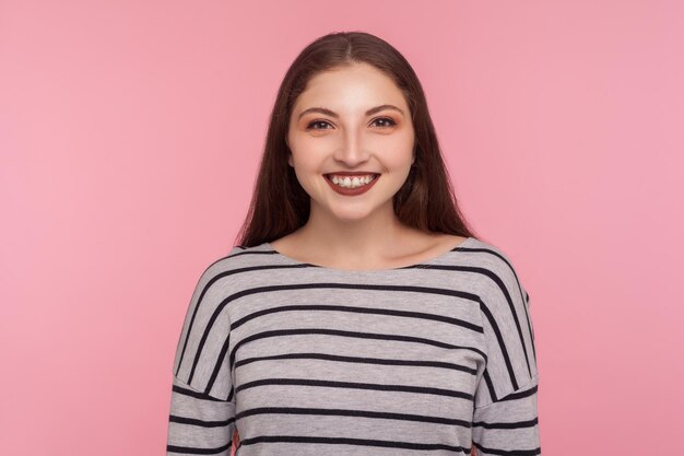 Portrait of emotional brunette young woman on pink background