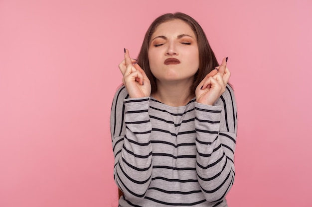 Portrait of emotional brunette young woman on pink background