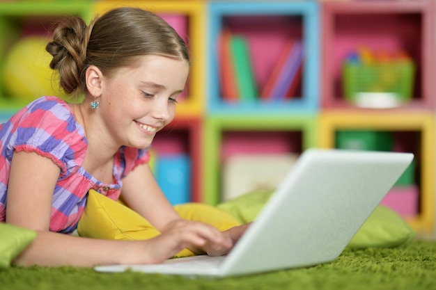 Portrait of emotional cue girl using modern laptop