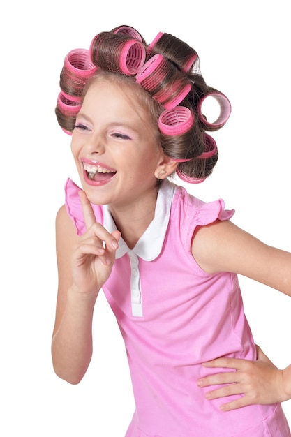 Portrait of emotional little pretty girl with hair curlers
