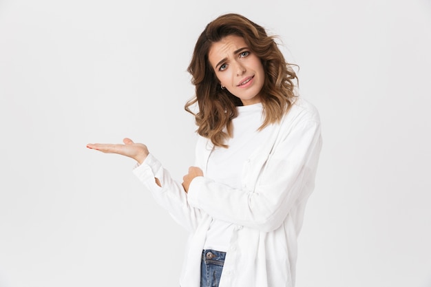 Portrait of emotional woman 30s in casual clothes standing, isolated over white