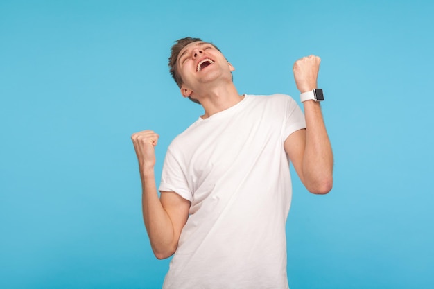 Portrait of emotional young man on blue background