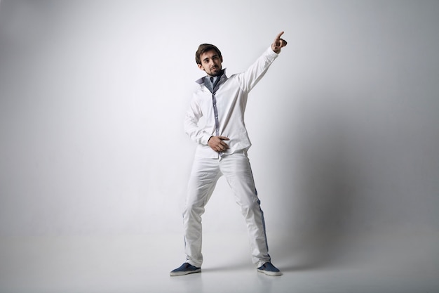 Photo portrait of an emotional young man wearing white. isolated over white background.