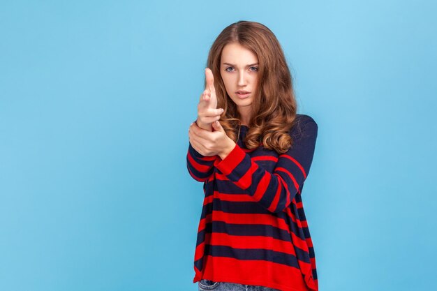 Portrait of emotional young woman on blue background