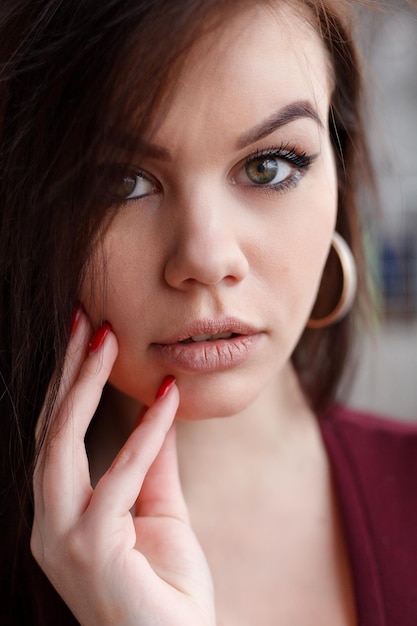 Portrait, emotions, people, beauty and lifestyle concept - Close up fashion portrait of seductive sexy woman with big blue eyes ,full lips , prefect skin and long fluffy curled hairstyle