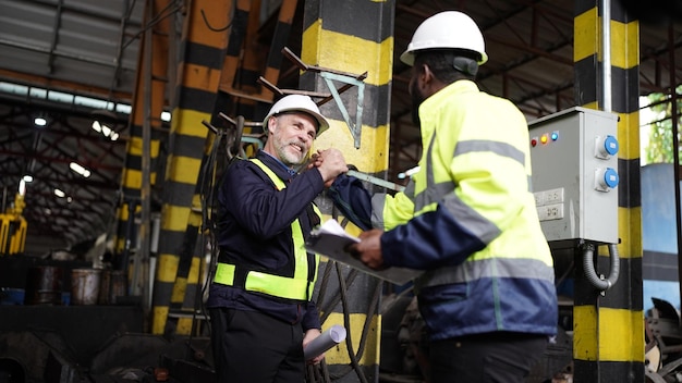 Portrait of engineer and apprentice in workshop of railway engineering facility