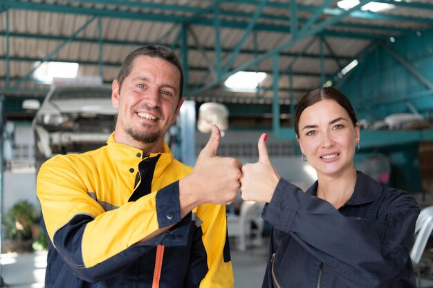 Portrait of engineer and auto mechanic with working on engine repairs in car garages