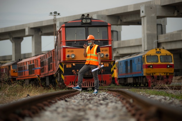 Photo portrait engineer under inspection and checking construction process railway switch.