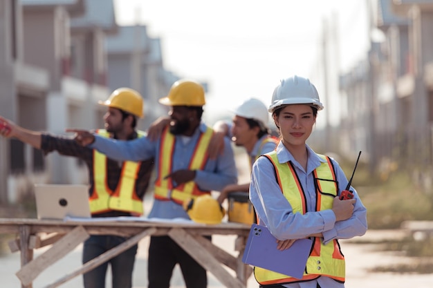 portrait of engineers work together to assess the residential home construction sites progress
