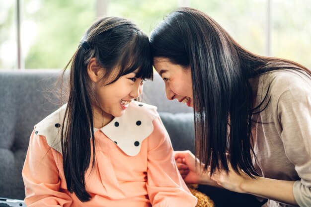 Portrait of enjoy happy love asian family mother and little asian girls child smiling and having fun