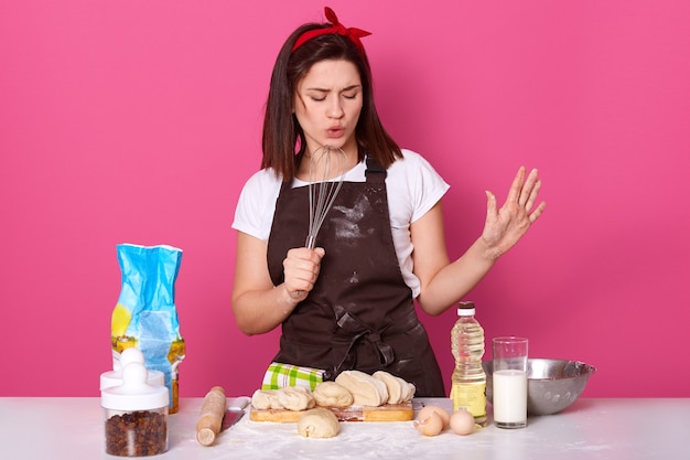 Portrait of enthusiastic active baker closing her eyes