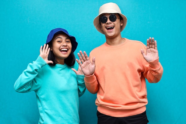 Portrait of excited Asian people man and woman in basic clothing screaming and rejoicing together is