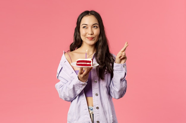 Portrait of excited attractive asian female making wish