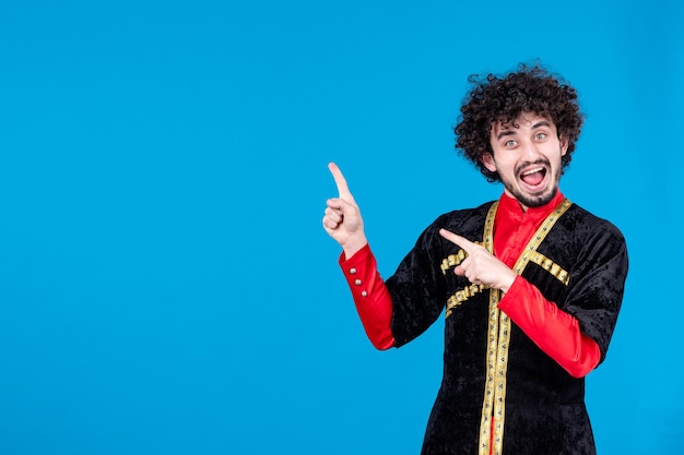 Portrait of excited azeri man in traditional costume on blue background ethnic dancer novruz spring