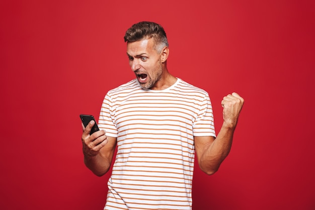 Portrait of an excited man standing on red