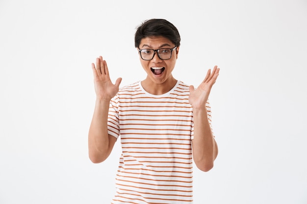 Portrait of an excited young asian man in sunglasses