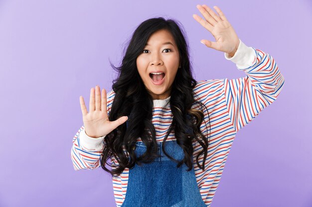 Portrait of an excited young asian woman isolated