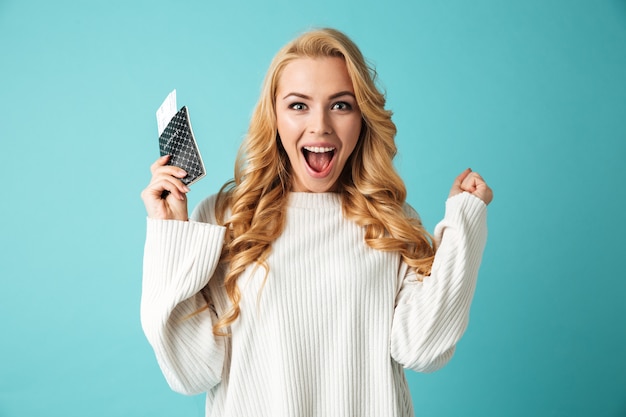 Portrait of an excited young blonde woman in sweater