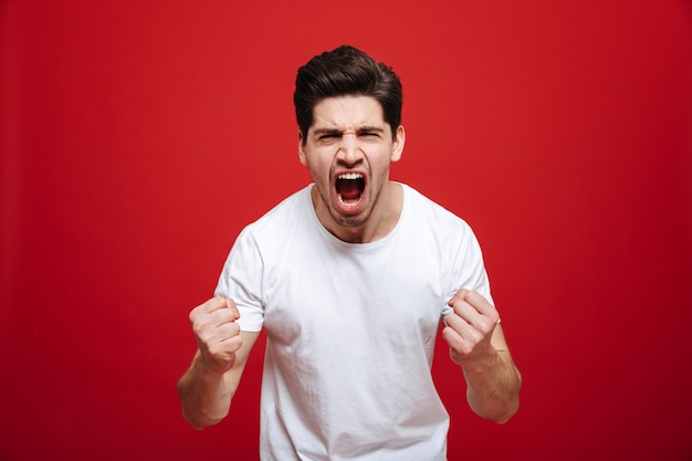 Portrait of an excited young man in white t-shirt