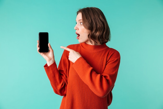 Portrait of an excited young woman dressed in sweater