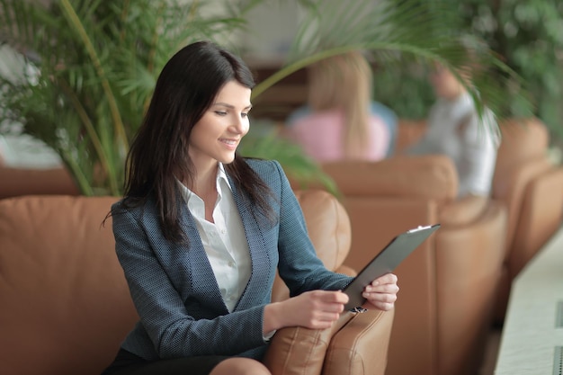 Portrait of an Executive business woman with a clipboard on the background of the business center