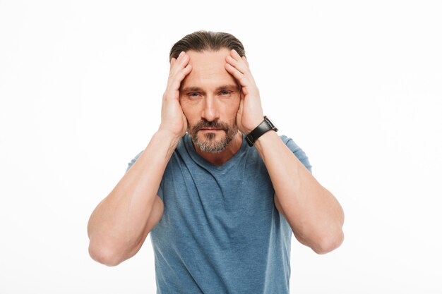 Portrait of an exhausted mature man dressed in t-shirt