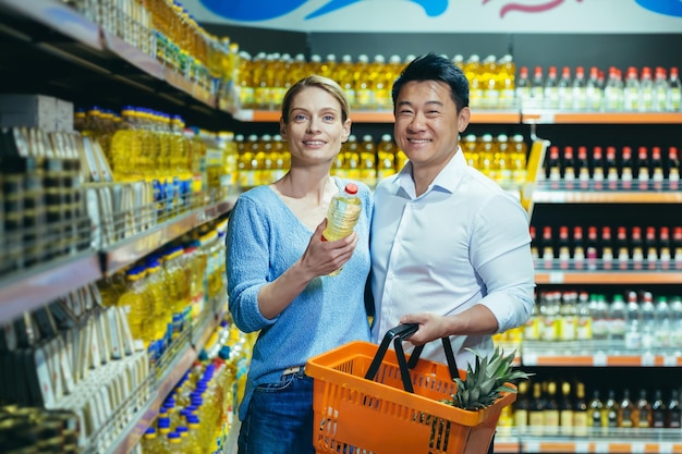 Portrait of experienced mature multiracial couple asian man and woman smiling and looking at camera