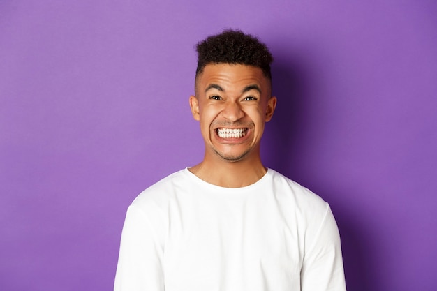 Portrait expressive young african man wearing white shirt