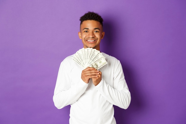 Portrait expressive young man holding banknotes