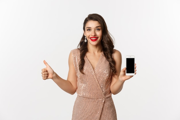 portrait expressive young woman in elegant dress holding phone