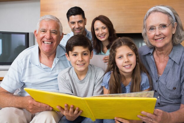 Portrait of an extended family looking at their album photo