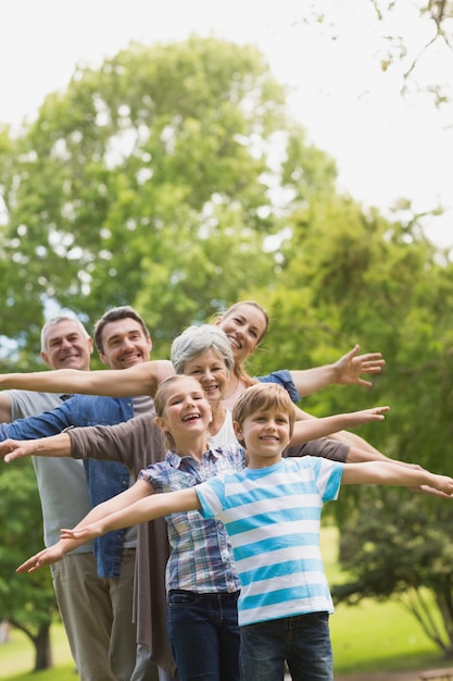 Portrait of an extended family stretching hands at the park