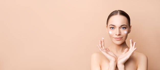 Portrait face cream and skincare for woman in studio for wellness beauty and care on grey background Facial product or sunscreen by lady relax in luxury cosmetic and lotion